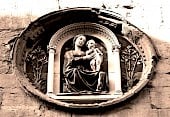 Ornate Madonna and Child statuettes in a niche  on building wall
